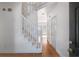 Bright foyer features hardwood floors, a staircase, and an entrance door with gold hardware at 1268 Windsor Glen Dr, Douglasville, GA 30134