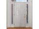 Exterior front door with sidelights and transom window offers natural light, painted white with golden hardware at 1268 Windsor Glen Dr, Douglasville, GA 30134