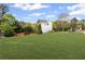 Well-manicured front yard with a lush lawn, mature trees, and landscaping enhancing curb appeal at 1268 Windsor Glen Dr, Douglasville, GA 30134