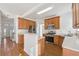 Well-lit kitchen with stainless steel appliances, wood cabinetry and a breakfast bar at 1268 Windsor Glen Dr, Douglasville, GA 30134