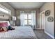 Comfortable bedroom featuring a quilted bed, striped curtains, carpet and neutral paint at 2852 Evanshire Ave # 114, Duluth, GA 30096