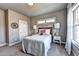 Cozy bedroom with a quilted bed, wood headboard, and lots of natural light from the window at 2852 Evanshire Ave # 114, Duluth, GA 30096