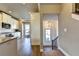 View of the entryway from the kitchen, featuring white shiplap and a modern light fixture at 2852 Evanshire Ave # 114, Duluth, GA 30096