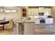 Bright kitchen with white cabinets, granite countertops, stainless steel appliances and hardwood floors at 2852 Evanshire Ave # 114, Duluth, GA 30096