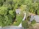 Aerial view of the home and surrounding neighborhood, featuring lush greenery, and a long driveway at 660 Willow Knoll Se Dr, Marietta, GA 30067
