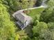 Aerial view of the home with a long driveway, well-maintained landscaping, and surrounded by lush greenery at 660 Willow Knoll Se Dr, Marietta, GA 30067