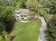 Aerial view of the home showcasing its architectural style, curb appeal, and lush landscaping and driveway at 660 Willow Knoll Se Dr, Marietta, GA 30067