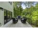 Covered outdoor deck with comfortable seating and a view of the lush green backyard at 660 Willow Knoll Se Dr, Marietta, GA 30067