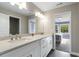 Modern bathroom with a double vanity, stone countertops, and a doorway to an adjoining bedroom at 660 Willow Knoll Se Dr, Marietta, GA 30067
