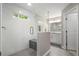 Modern bathroom featuring a glass-enclosed shower, gray tile, and sleek vanity at 660 Willow Knoll Se Dr, Marietta, GA 30067