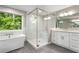 Spa-like bathroom showcasing a modern glass shower, soaking tub, and double vanity with premium finishes at 660 Willow Knoll Se Dr, Marietta, GA 30067