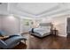 Main bedroom boasts trey ceilings, hardwood floors, and two lounge chairs at 660 Willow Knoll Se Dr, Marietta, GA 30067