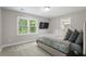 Cozy bedroom with a large window, mounted TV, and comfortable bed with decorative pillows at 660 Willow Knoll Se Dr, Marietta, GA 30067