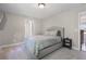 Comfortable bedroom with neutral colors, a plush bed, and a convenient side table at 660 Willow Knoll Se Dr, Marietta, GA 30067