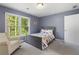 Cozy bedroom with a serene view, featuring soft carpet and a comfortable rocking chair at 660 Willow Knoll Se Dr, Marietta, GA 30067