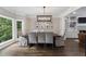 Bright dining room features dark hardwood floors and a modern chandelier at 660 Willow Knoll Se Dr, Marietta, GA 30067