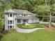 Beautiful two-story home featuring manicured lawn and lush landscaping at 660 Willow Knoll Se Dr, Marietta, GA 30067