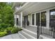 Charming front porch with black railings and a welcoming entrance at 660 Willow Knoll Se Dr, Marietta, GA 30067