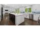 Open kitchen with a large island, stainless steel appliances, and view to the living room with fireplace at 660 Willow Knoll Se Dr, Marietta, GA 30067