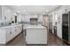A beautifully updated white kitchen boasts stainless steel appliances, an island, and a wine fridge at 660 Willow Knoll Se Dr, Marietta, GA 30067
