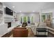 Cozy living room features a fireplace, built-in bookshelves, and patio doors at 660 Willow Knoll Se Dr, Marietta, GA 30067