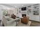 Spacious living room with a fireplace, shelving, and seamless flow to dining at 660 Willow Knoll Se Dr, Marietta, GA 30067