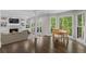Bright living room with fireplace, built-ins, and a dining area with large windows showcasing the wooded view at 660 Willow Knoll Se Dr, Marietta, GA 30067
