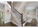 Elegant staircase with dark wood floors and white trim accents at 660 Willow Knoll Se Dr, Marietta, GA 30067