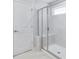 Bathroom featuring tiled shower with glass door, bench, and a small window at 108 Aj Welch Jr Way, Mcdonough, GA 30252