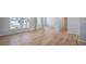Bright open-concept living space featuring hardwood floors and large windows at 108 Aj Welch Jr Way, Mcdonough, GA 30252