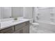 Well-lit bathroom features a modern vanity with stone countertop and a bathtub/shower combo at 124 Aj Welch Jr Way, Mcdonough, GA 30252