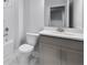 Modern bathroom features sleek gray vanity, elegant marble floors, and pristine white tub, offering spa-like comfort at 124 Aj Welch Jr Way, Mcdonough, GA 30252