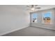 Bright bedroom with neutral carpet, ceiling fan, and two windows offering natural light at 124 Aj Welch Jr Way, Mcdonough, GA 30252