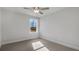 Cozy bedroom with neutral carpet, a ceiling fan, and a window view of the outdoors at 124 Aj Welch Jr Way, Mcdonough, GA 30252