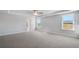 Spacious bedroom with gray carpet, baseboards, tray ceiling and bright windows, with an ensuite bathroom at 124 Aj Welch Jr Way, Mcdonough, GA 30252