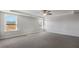 Large, bright bedroom featuring tray ceiling, a fan and bright windows at 124 Aj Welch Jr Way, Mcdonough, GA 30252