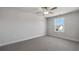 This bedroom has carpet flooring, trim, baseboards, a window and light gray walls at 124 Aj Welch Jr Way, Mcdonough, GA 30252
