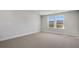 This bedroom has carpet flooring, trim, baseboards, a window and light gray walls at 124 Aj Welch Jr Way, Mcdonough, GA 30252