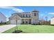 Stunning two-story brick home with a welcoming front porch and well-manicured lawn, showcasing classic design at 124 Aj Welch Jr Way, Mcdonough, GA 30252