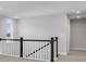 Upstairs hallway featuring decorative railing and natural light at 124 Aj Welch Jr Way, Mcdonough, GA 30252