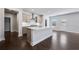 Bright kitchen featuring a large island, stainless steel appliances, and dark wood floors, perfect for culinary enthusiasts at 124 Aj Welch Jr Way, Mcdonough, GA 30252