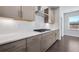 Modern kitchen features sleek countertops, stainless steel range hood, and stylish cabinets at 124 Aj Welch Jr Way, Mcdonough, GA 30252