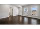Spacious living room with gleaming hardwood floors and bright windows, offering a seamless flow and inviting ambiance at 124 Aj Welch Jr Way, Mcdonough, GA 30252