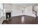 Spacious living room with hardwood floors, large windows, and cozy fireplace at 124 Aj Welch Jr Way, Mcdonough, GA 30252