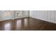 Elegant living room features rich hardwood floors, wainscoting detail, and sunlit windows, creating a welcoming space at 124 Aj Welch Jr Way, Mcdonough, GA 30252
