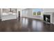Open living area featuring hardwood floors, recessed lighting, fireplace, and kitchen area at 124 Aj Welch Jr Way, Mcdonough, GA 30252