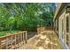 A wooden back deck overlooks a lush, green yard with wooden railing at 1248 Conway Rd, Decatur, GA 30030