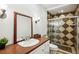 Bathroom featuring shower stall with patterned tile surround, with vanity and sink at 1248 Conway Rd, Decatur, GA 30030