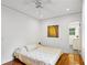Bright bedroom with hardwood floors, ceiling fan and ensuite bathroom with shower at 1248 Conway Rd, Decatur, GA 30030