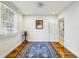 Bright bedroom featuring hardwood floors, a large window, and a classic blue area rug at 1248 Conway Rd, Decatur, GA 30030